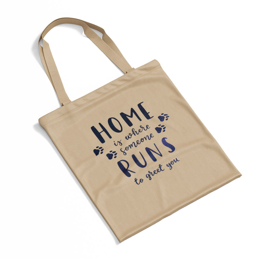 Home Is Where Someone Runs To Greet You With Paws With Green Galaxy Font Totes at $22.95 found at Personalizedpetlovergifts