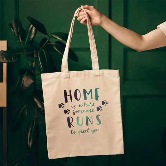 Home Is Where Someone Runs To Greet You With Paws With Star Font Totes at $22.95 found at Personalizedpetlovergifts