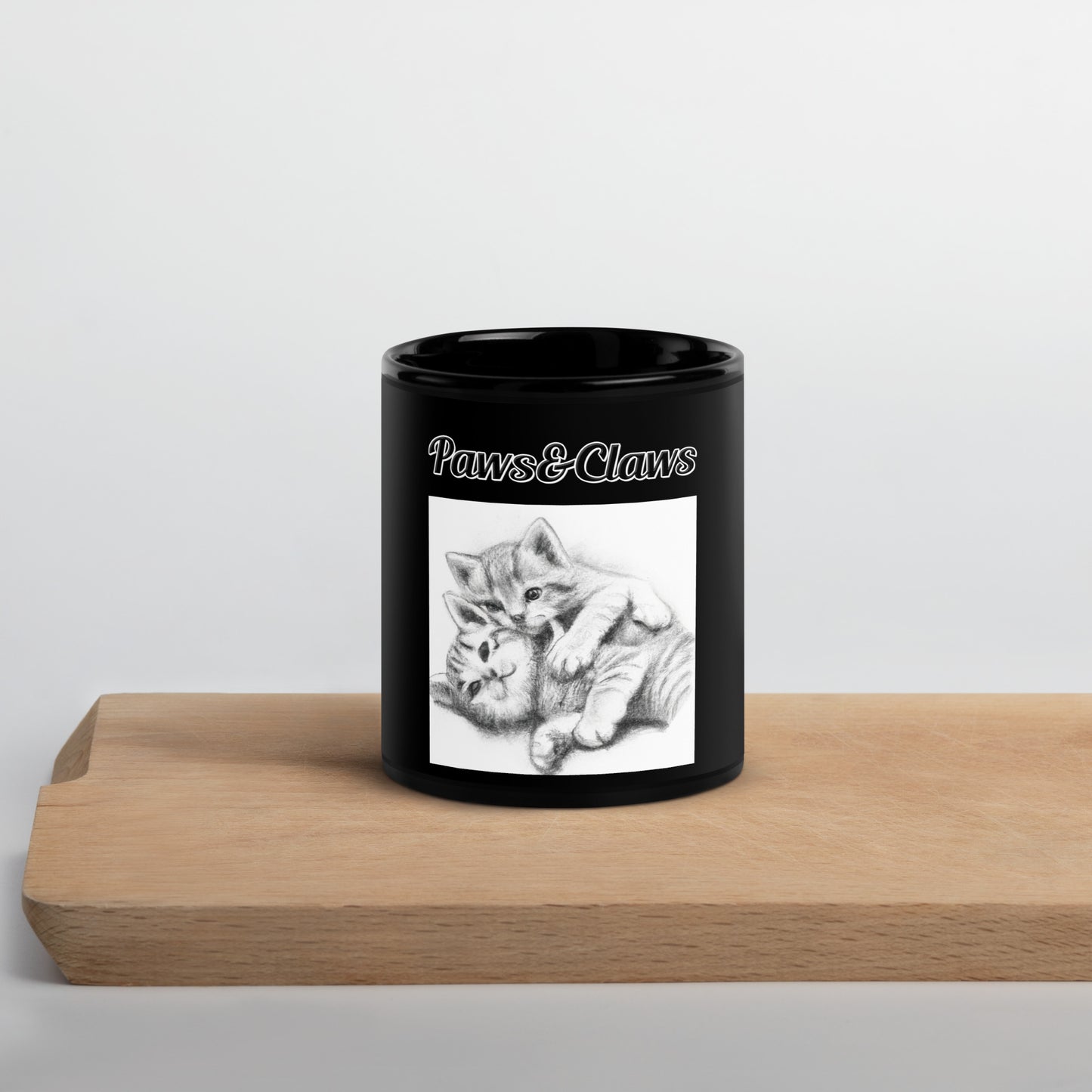 Black Glossy Mug with text Two Cute Kittens Hugging Pencil Drawing with a text "Paws&Claws" at $17.99 found at Personalizedpetlovergifts