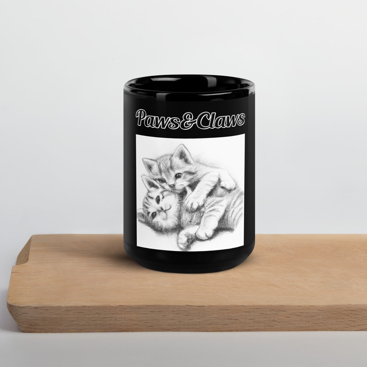 Black Glossy Mug with text Two Cute Kittens Hugging Pencil Drawing with a text "Paws&Claws" at $17.99 found at Personalizedpetlovergifts